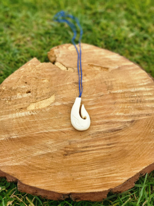 carved bone matau (hook) necklace with koru carvings on black cord
