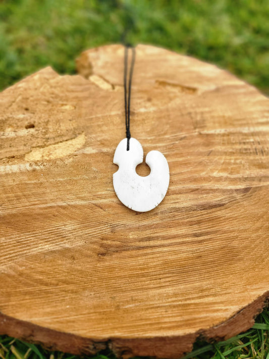 beautifully carved bone matau (hook) necklace with black cord