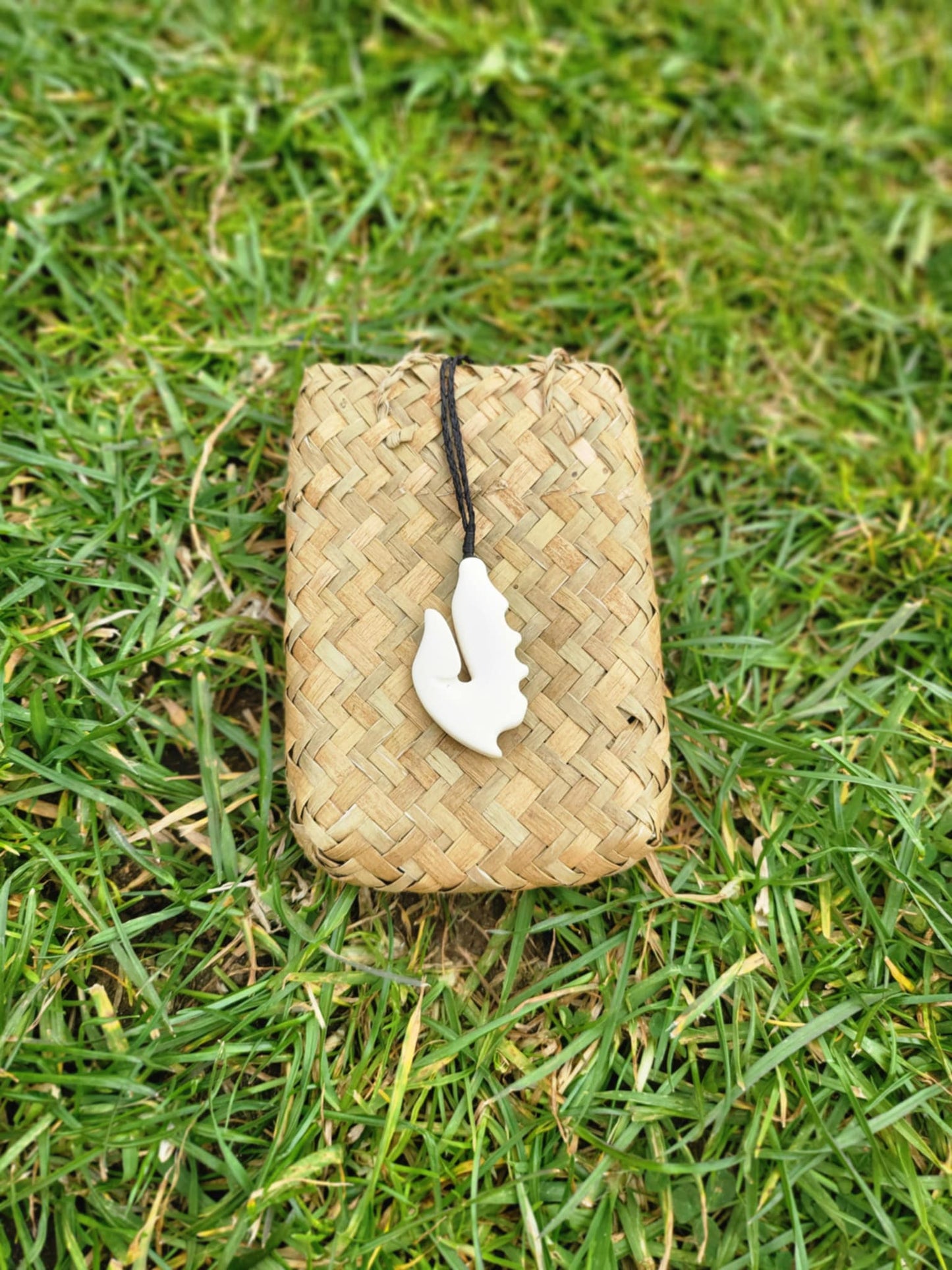 carved bone matau (hook) necklace on black cord