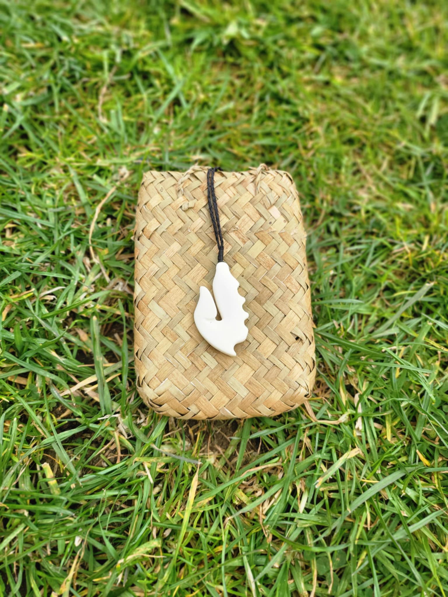 carved bone matau (hook) necklace on black cord