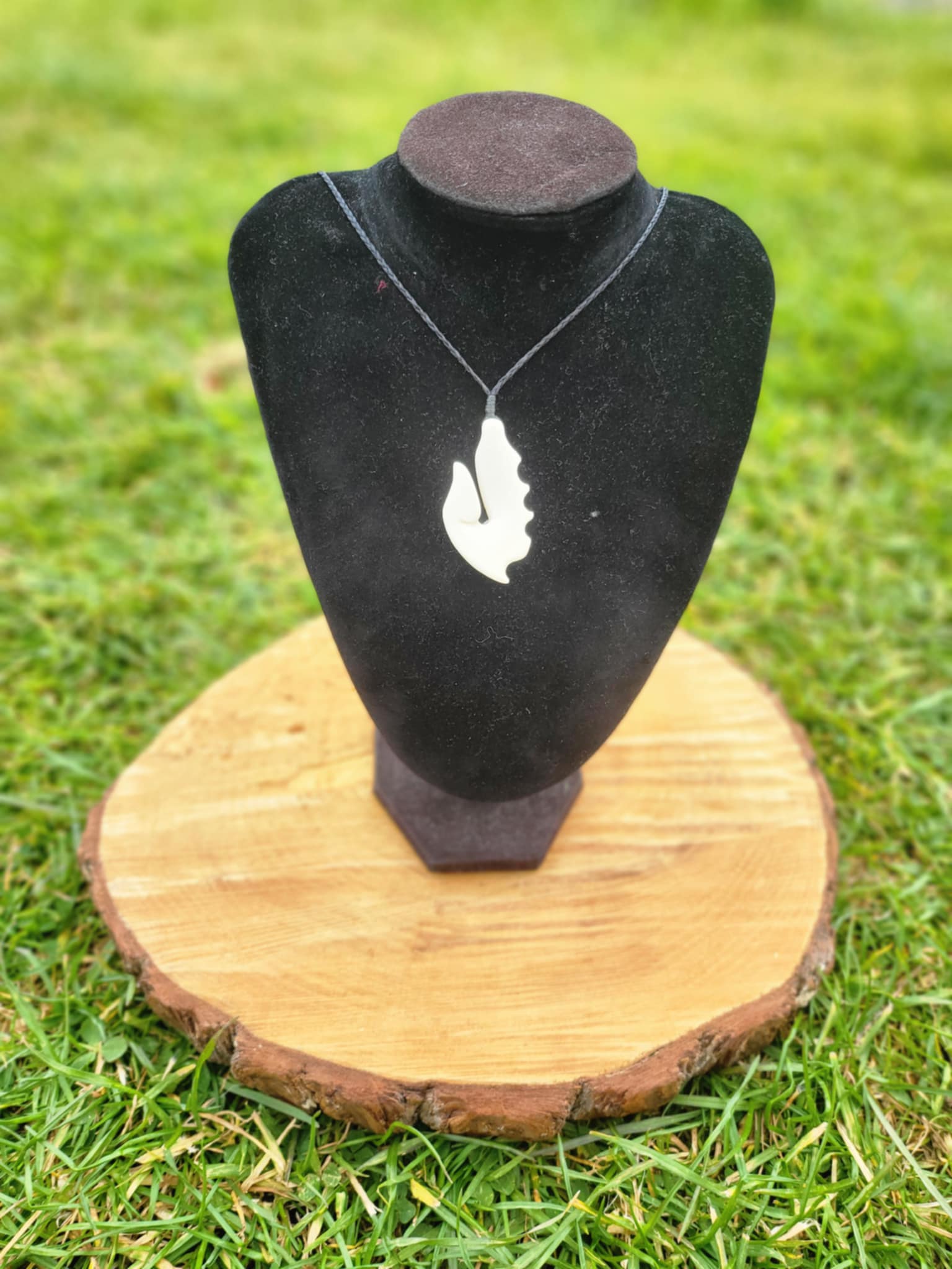 carved bone matau (hook) necklace on black cord
