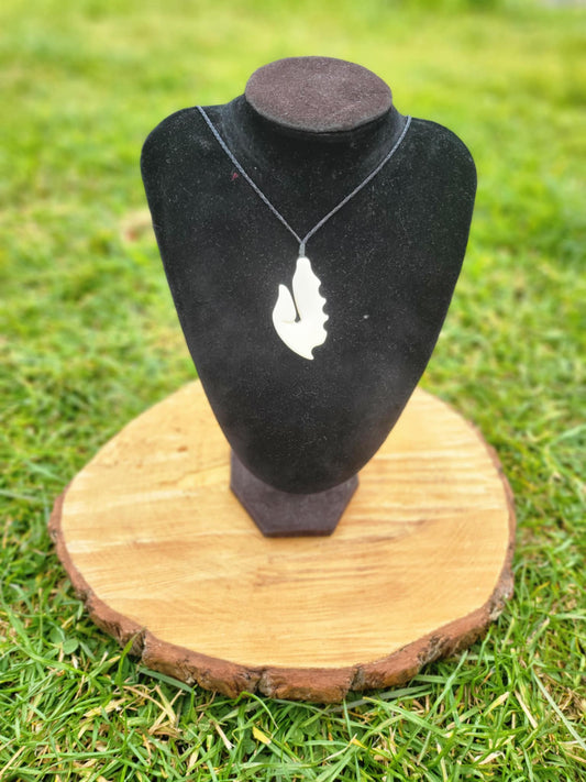 carved bone matau (hook) necklace on black cord