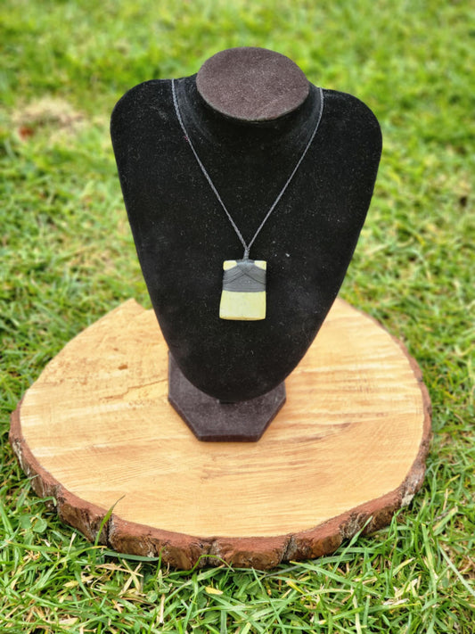 light green pounamu carved toki (adze) necklace on black cord