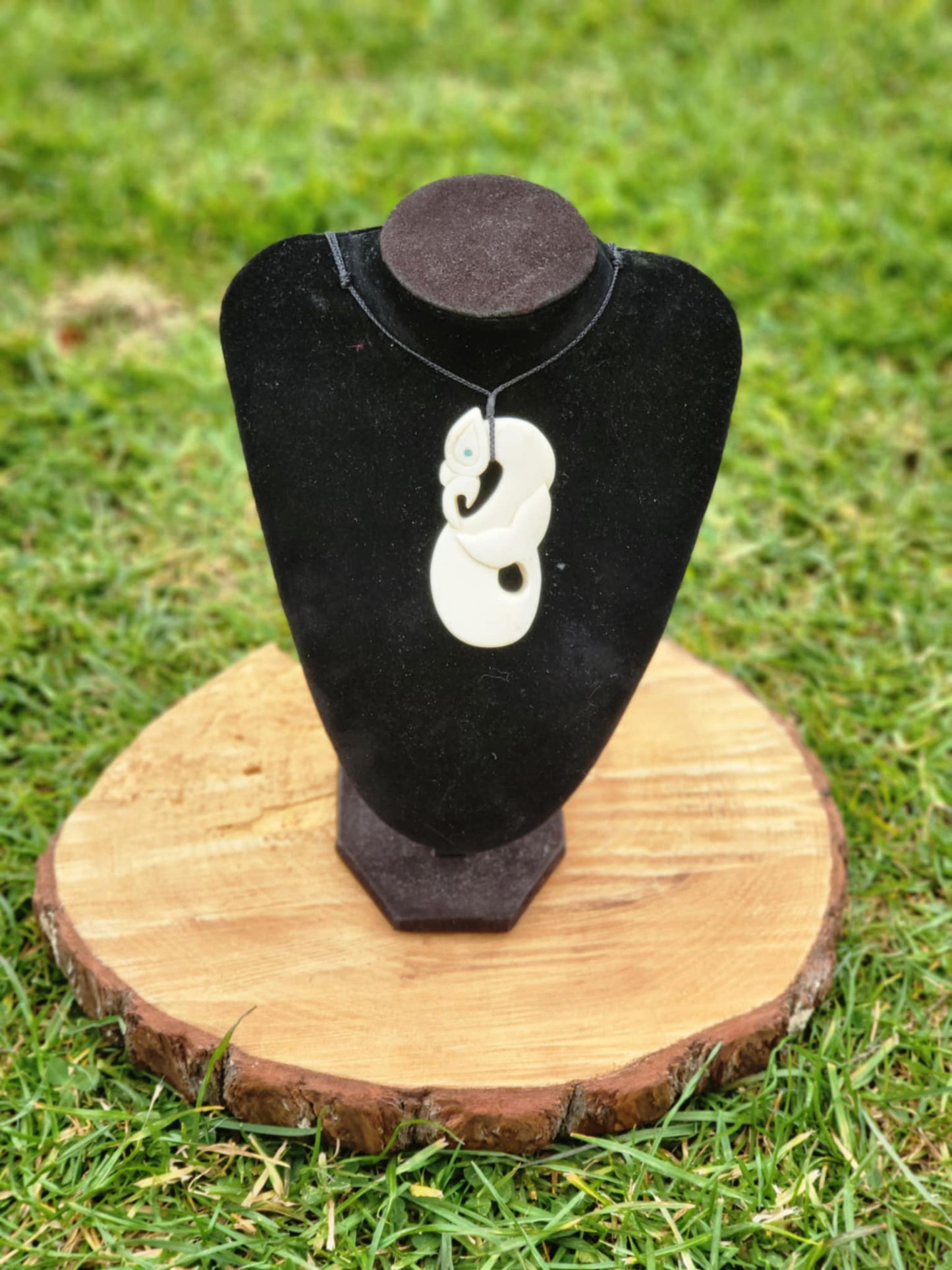 carved bone manaia necklace with whale tail on black cord