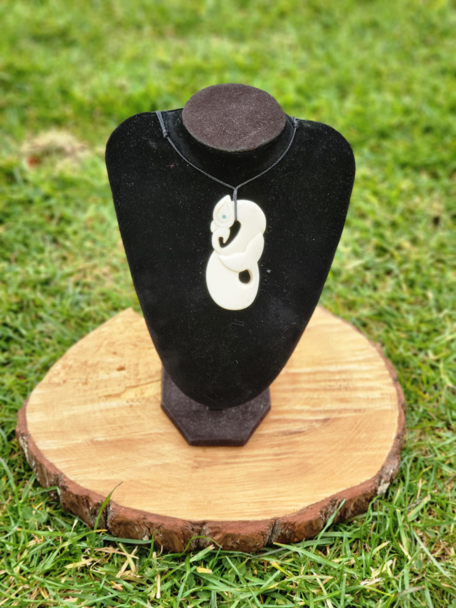 carved bone manaia necklace with whale tail on black cord