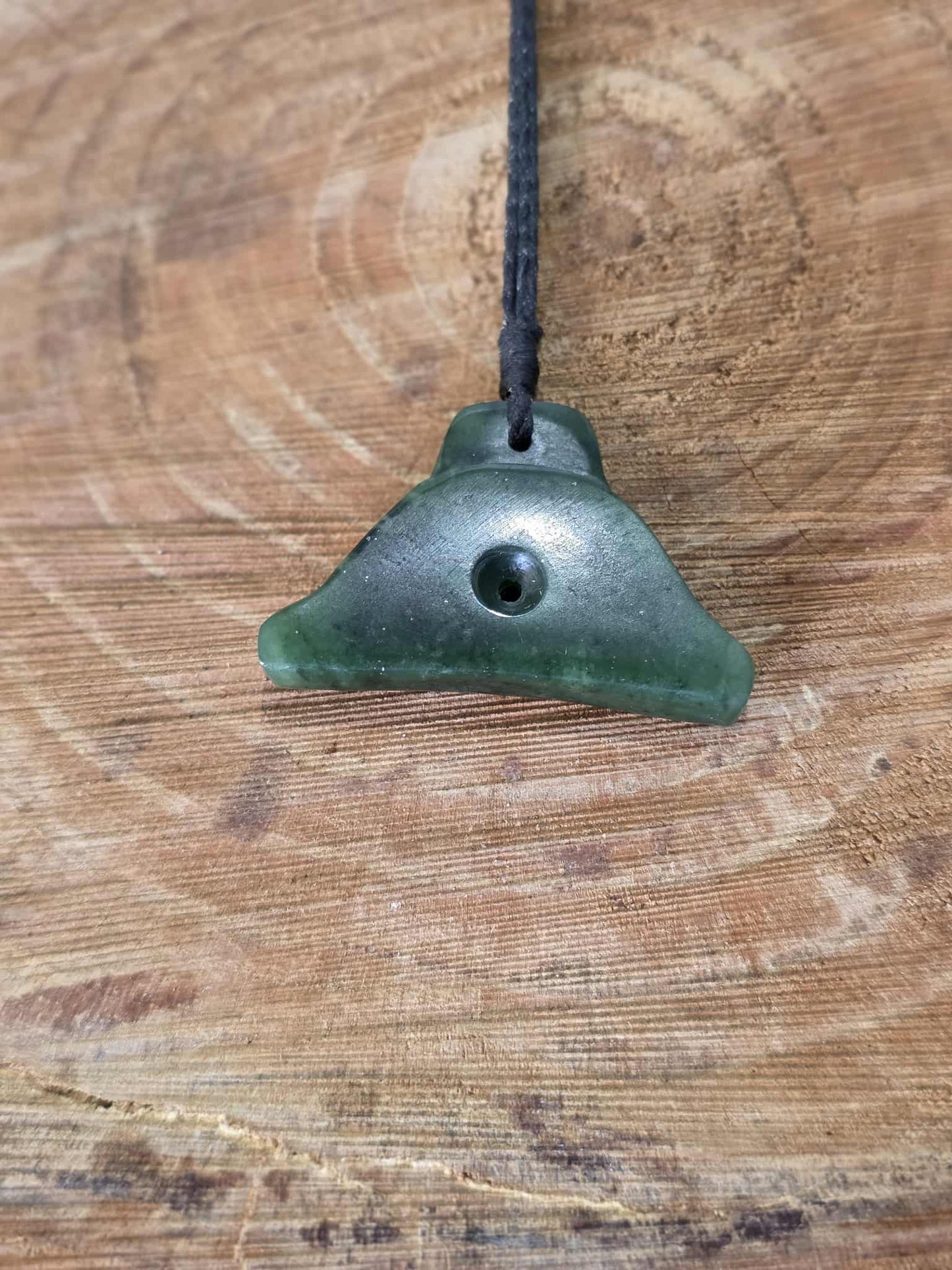 Pounamu (greenstone) shepherds whistle necklace on black braid