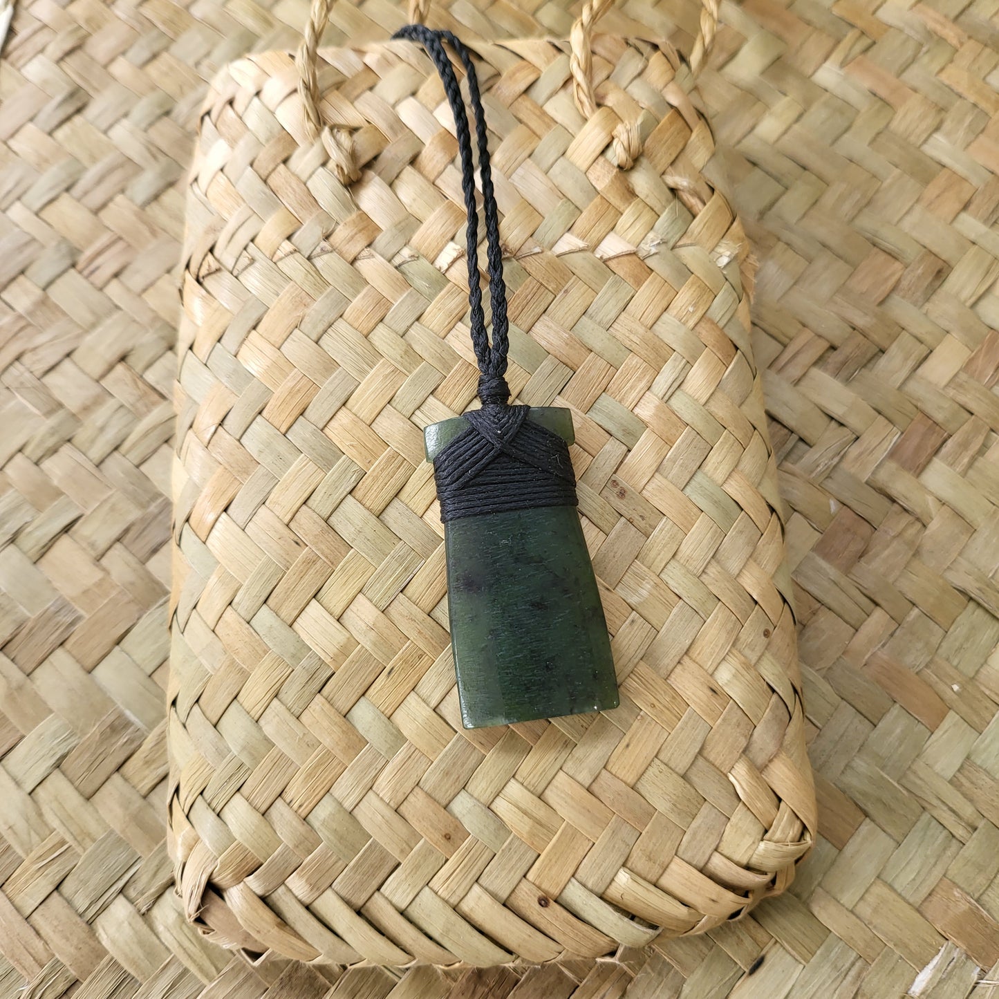 carved pounamu toki (adze) necklace, on black cord