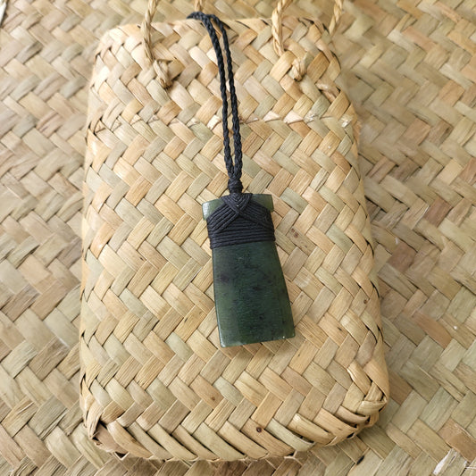 carved pounamu toki (adze) necklace, on black cord