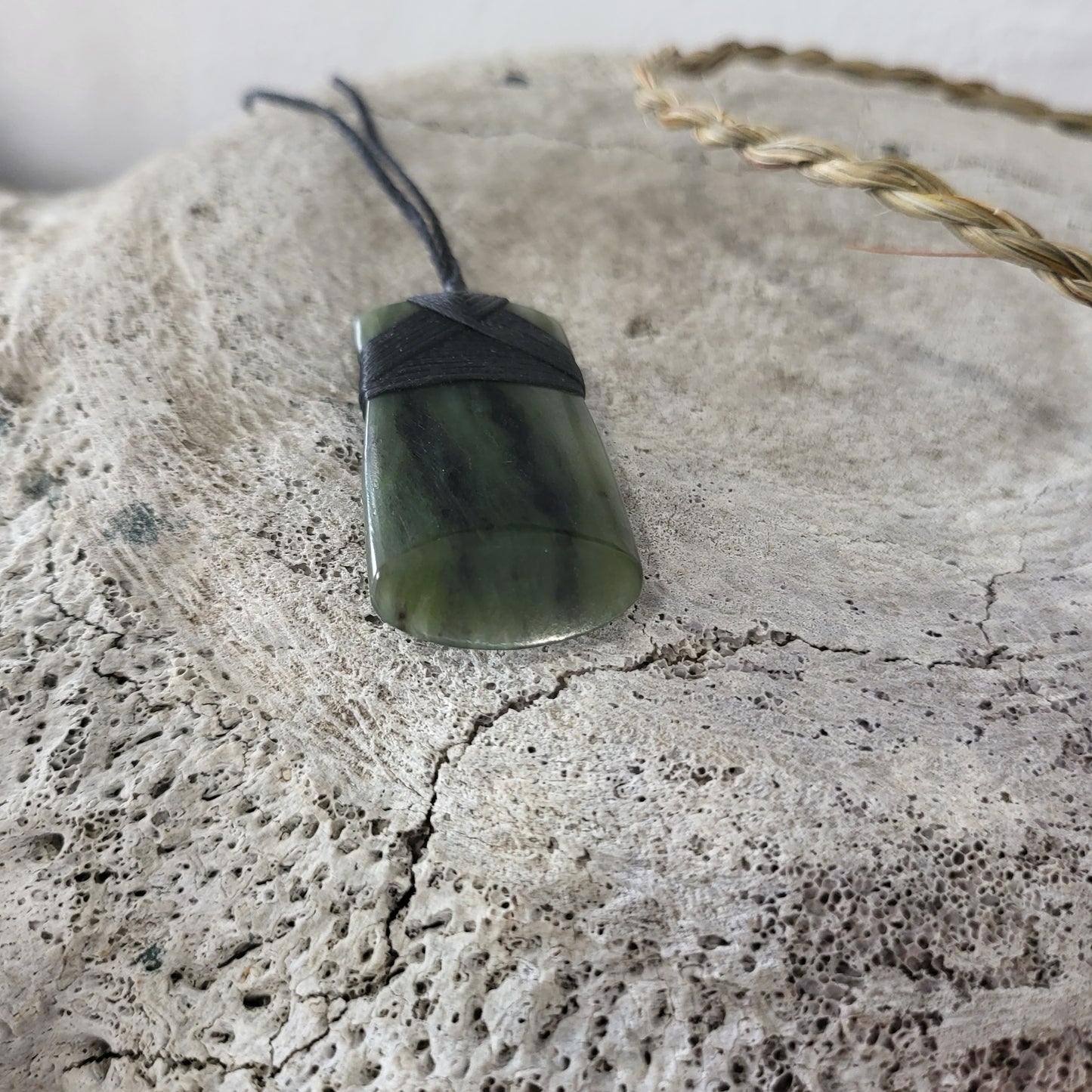 carved pounamu toki (adze) necklace, beautiful colour variations, on black cord