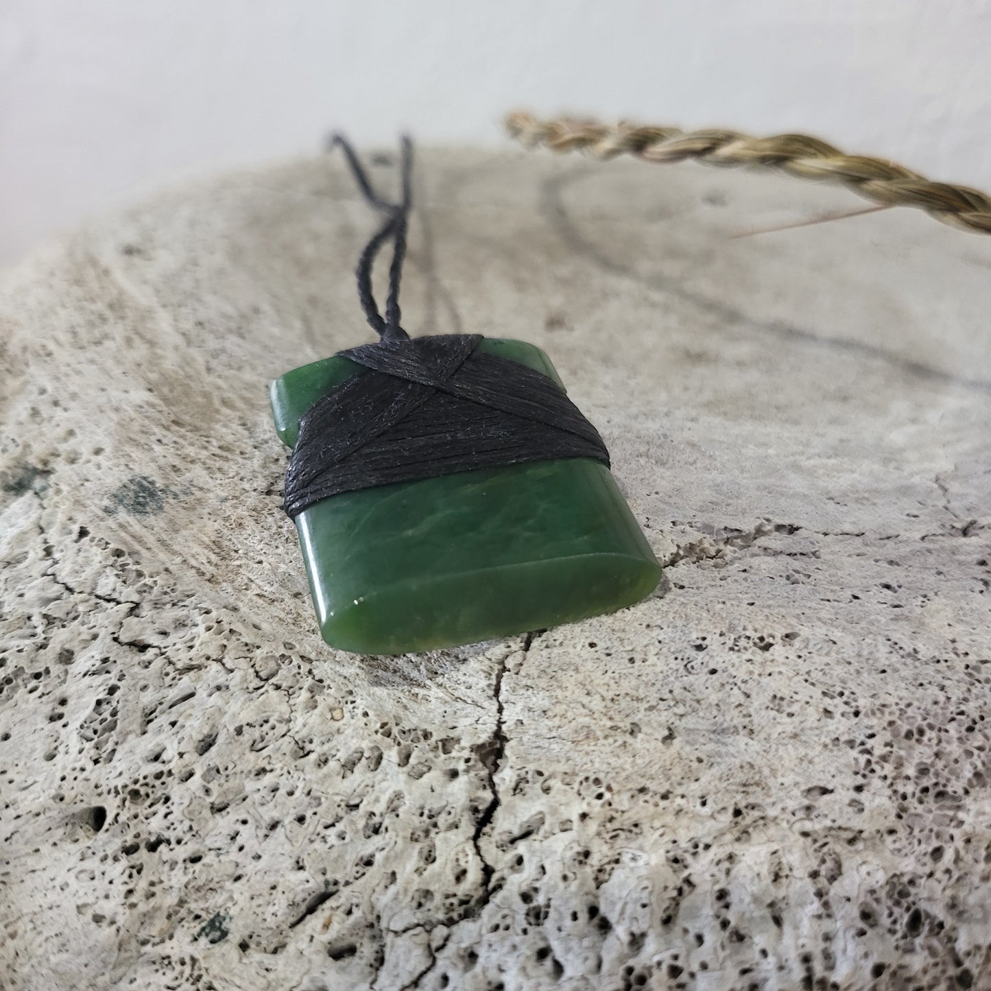 small carved pounamu toki (adze) necklace, on black cord