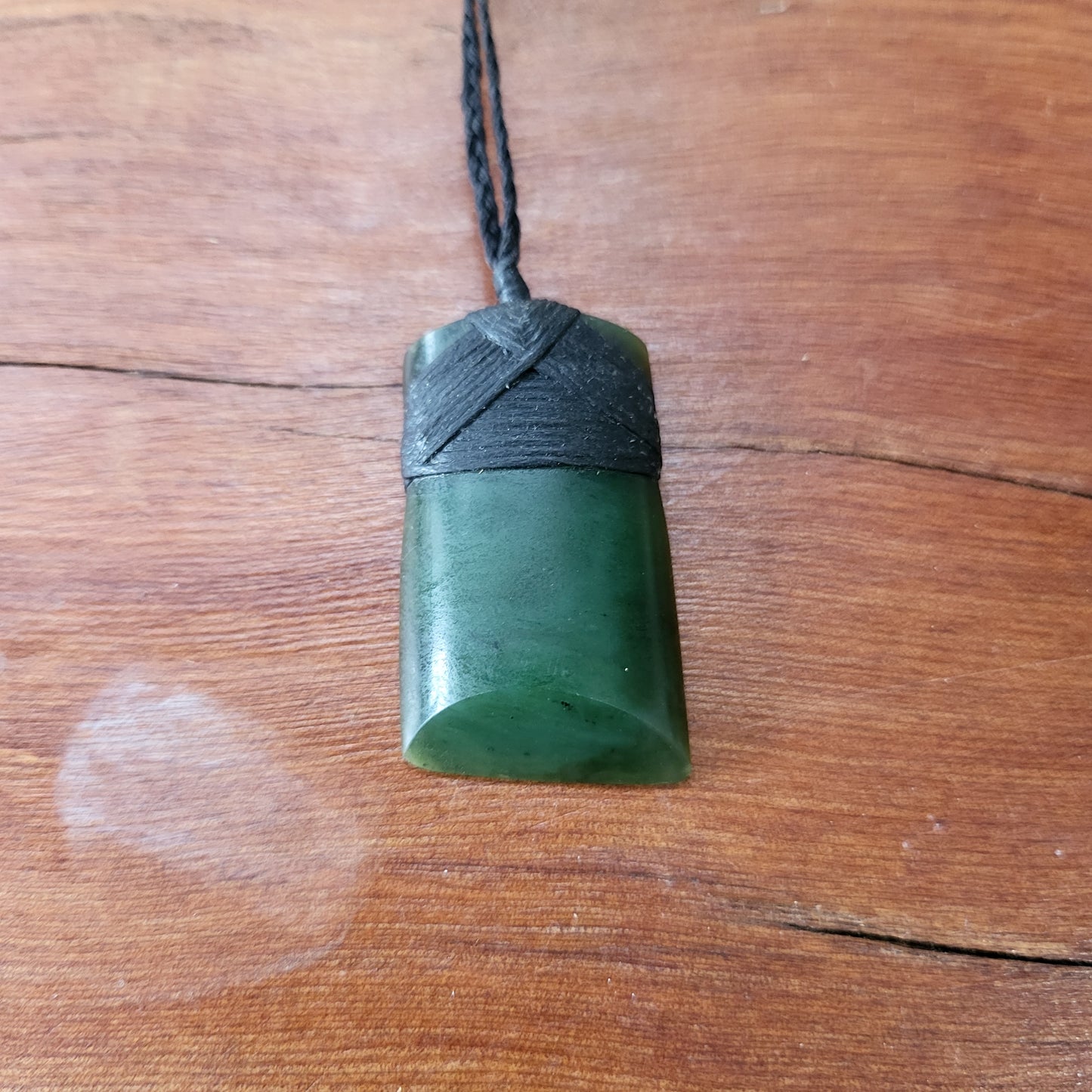carved pounamu toki (adze) necklace, on black cord