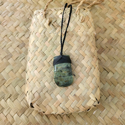 small carved pounamu toki (adze) necklace light green colour variations on black cord