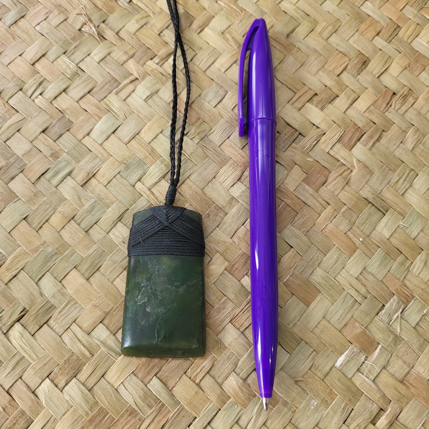 carved pounamu toki (adze) necklace, beautiful colour variations, on black cord
