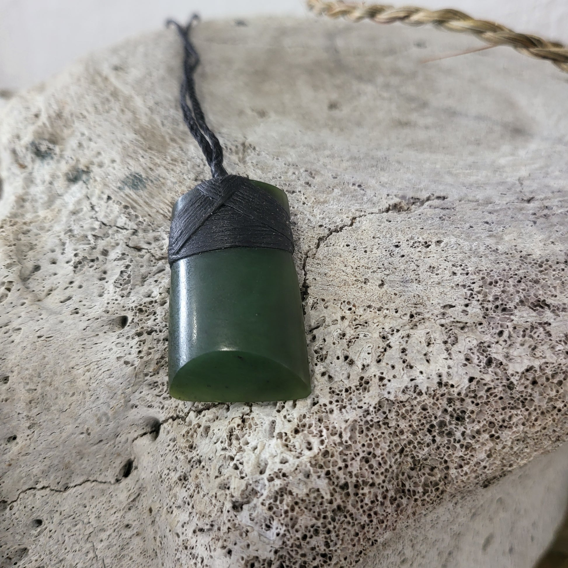 carved pounamu toki (adze) necklace, on black cord