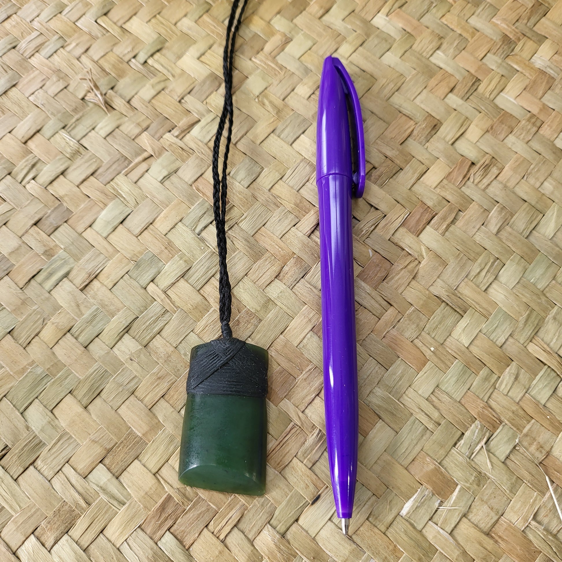 carved pounamu toki (adze) necklace, on black cord