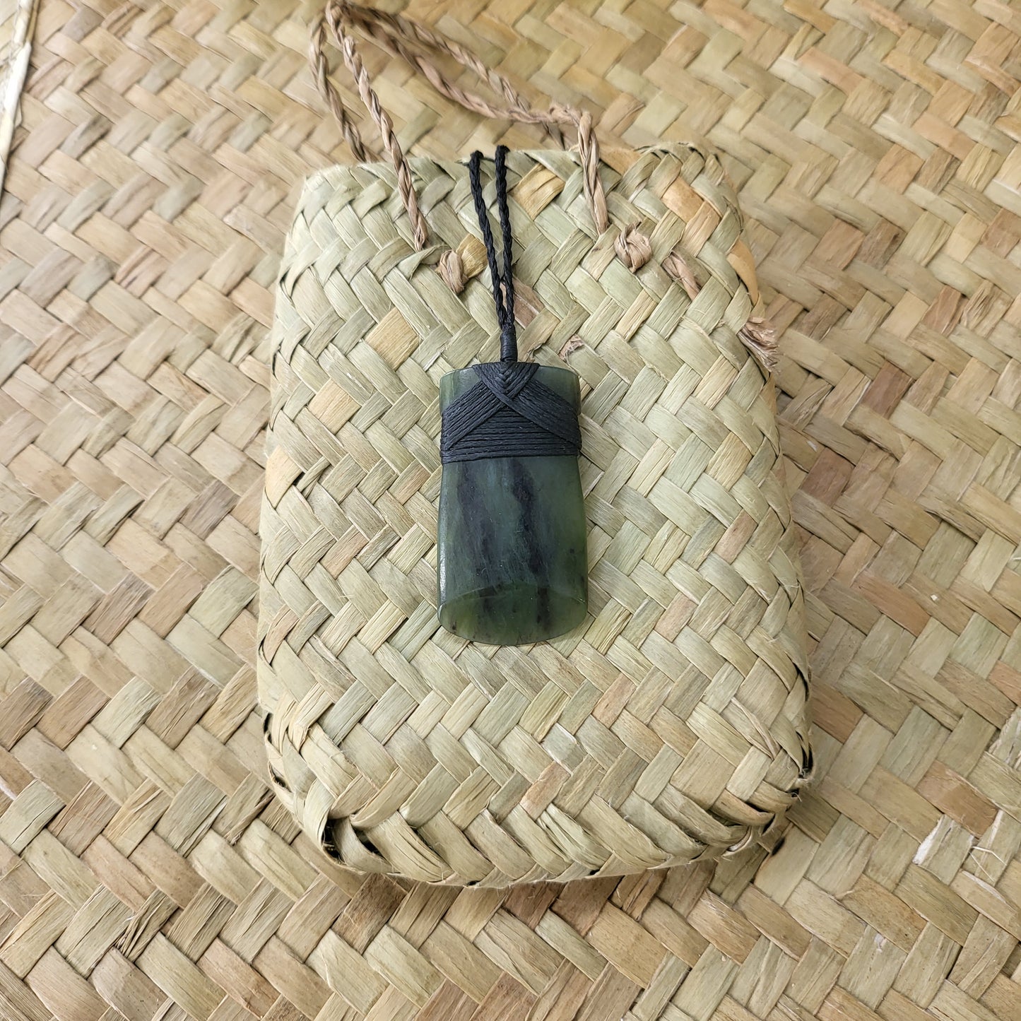 carved pounamu toki (adze) necklace, beautiful colour variations, on black cord