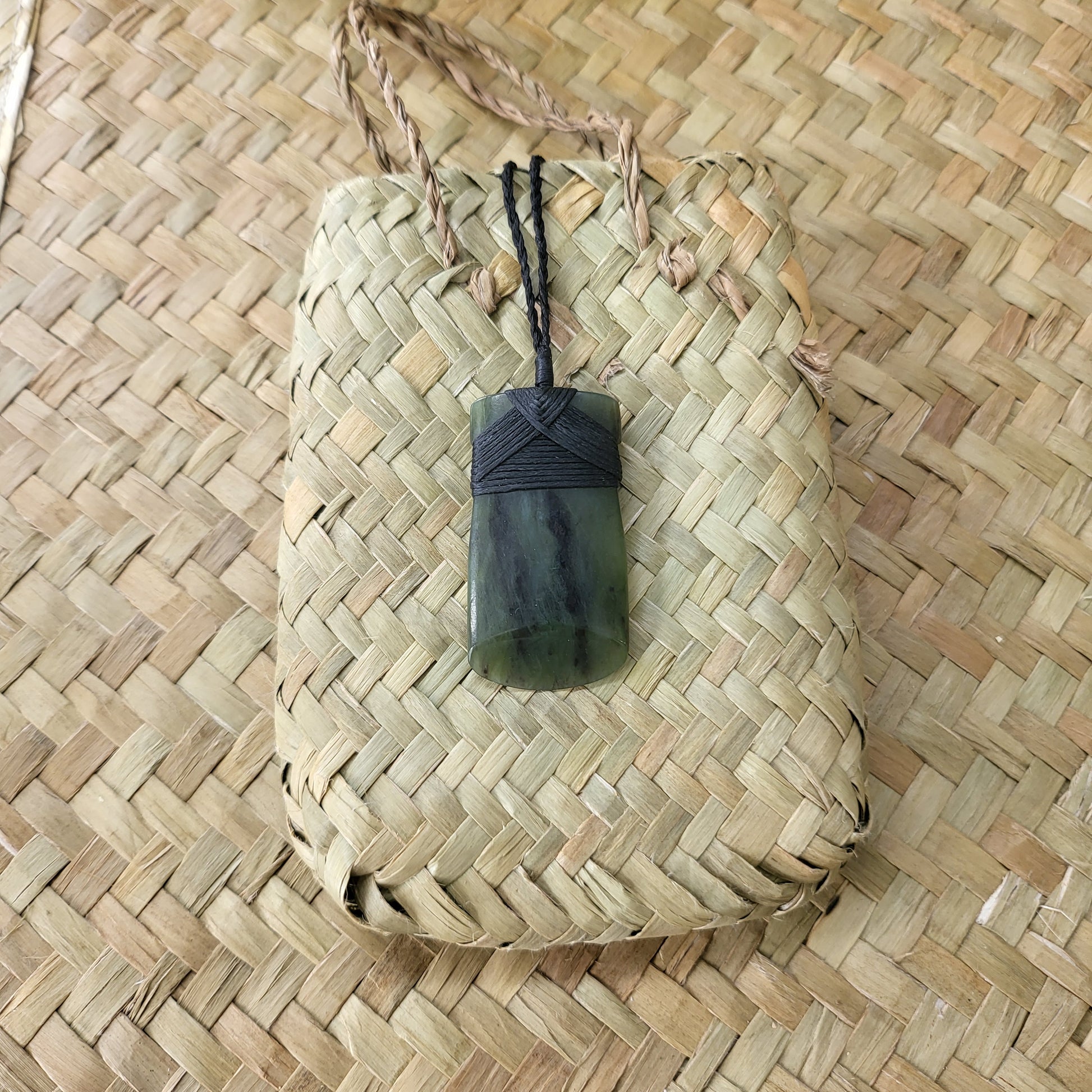 carved pounamu toki (adze) necklace, beautiful colour variations, on black cord