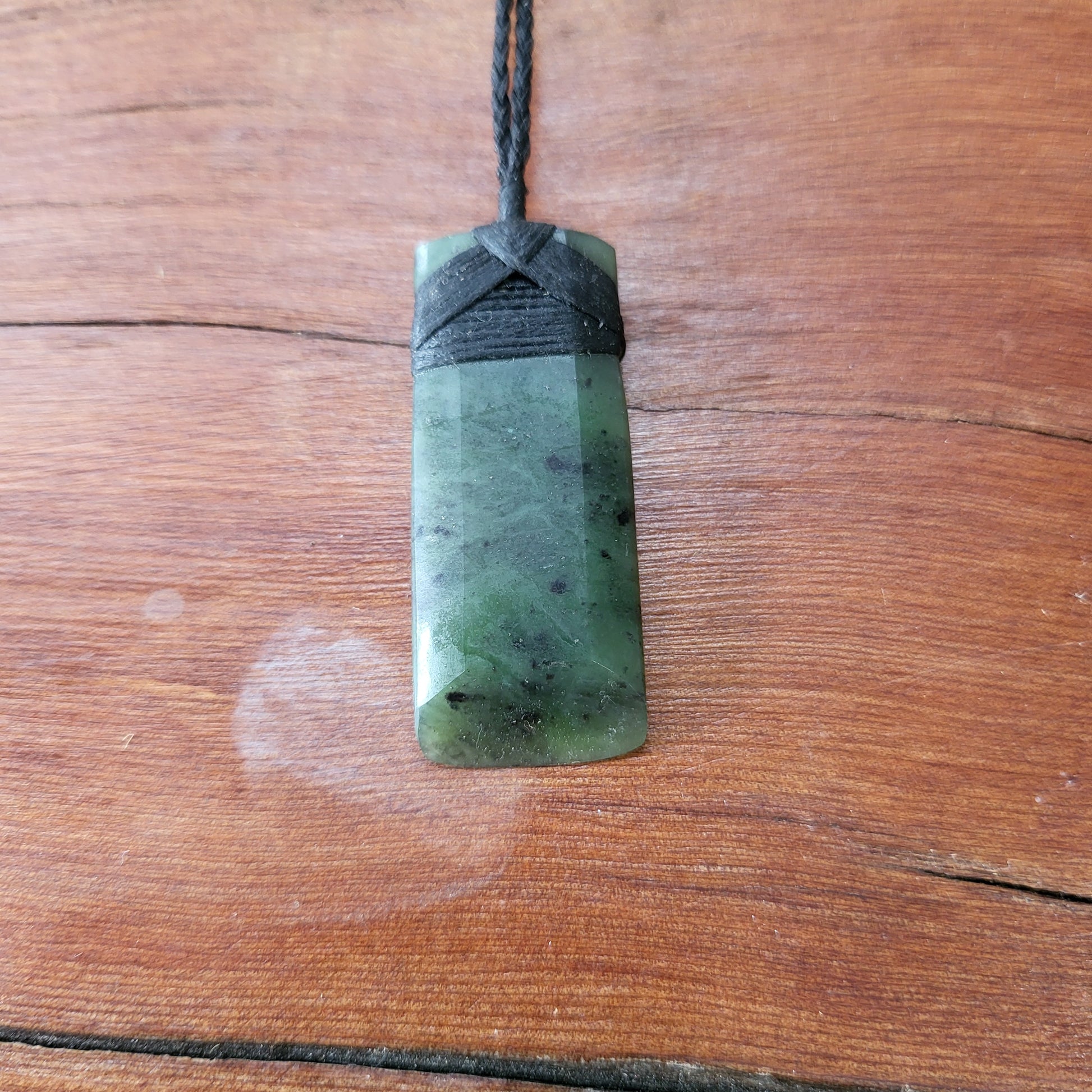 carved pounamu toki (adze) necklace, on black cord