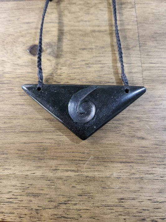carved pounamu chest plate necklace on black cord with koru design