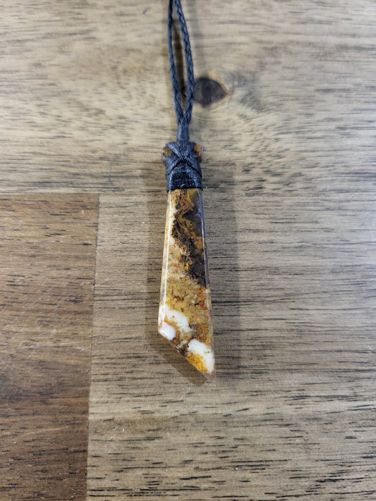 carved gemstone toki (adze) on black cord