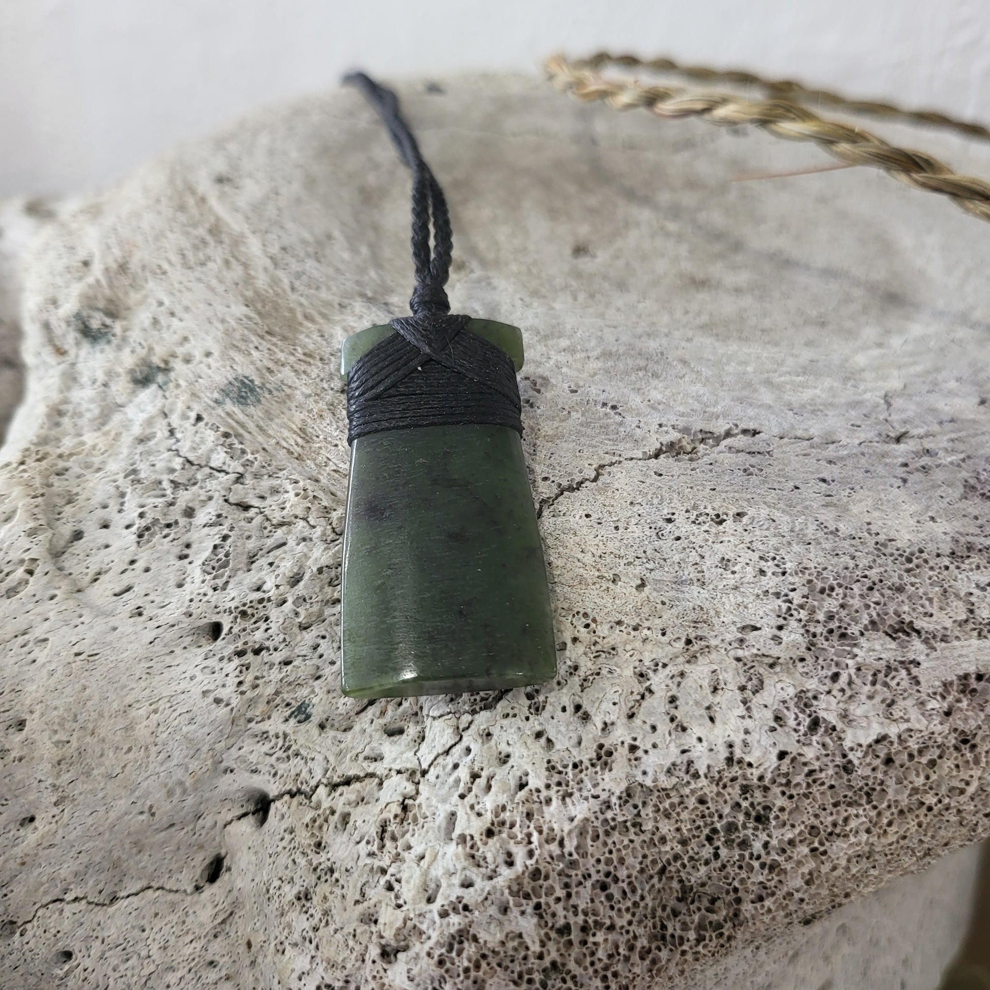 carved pounamu toki (adze) necklace, on black cord
