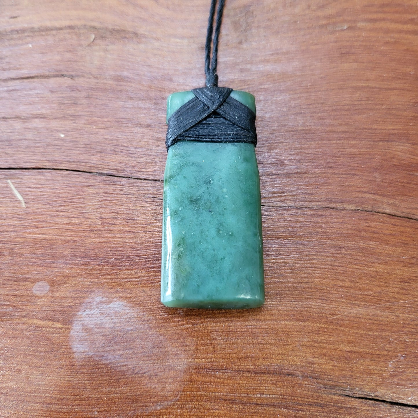 carved pounamu toki (adze) necklace, on black cord