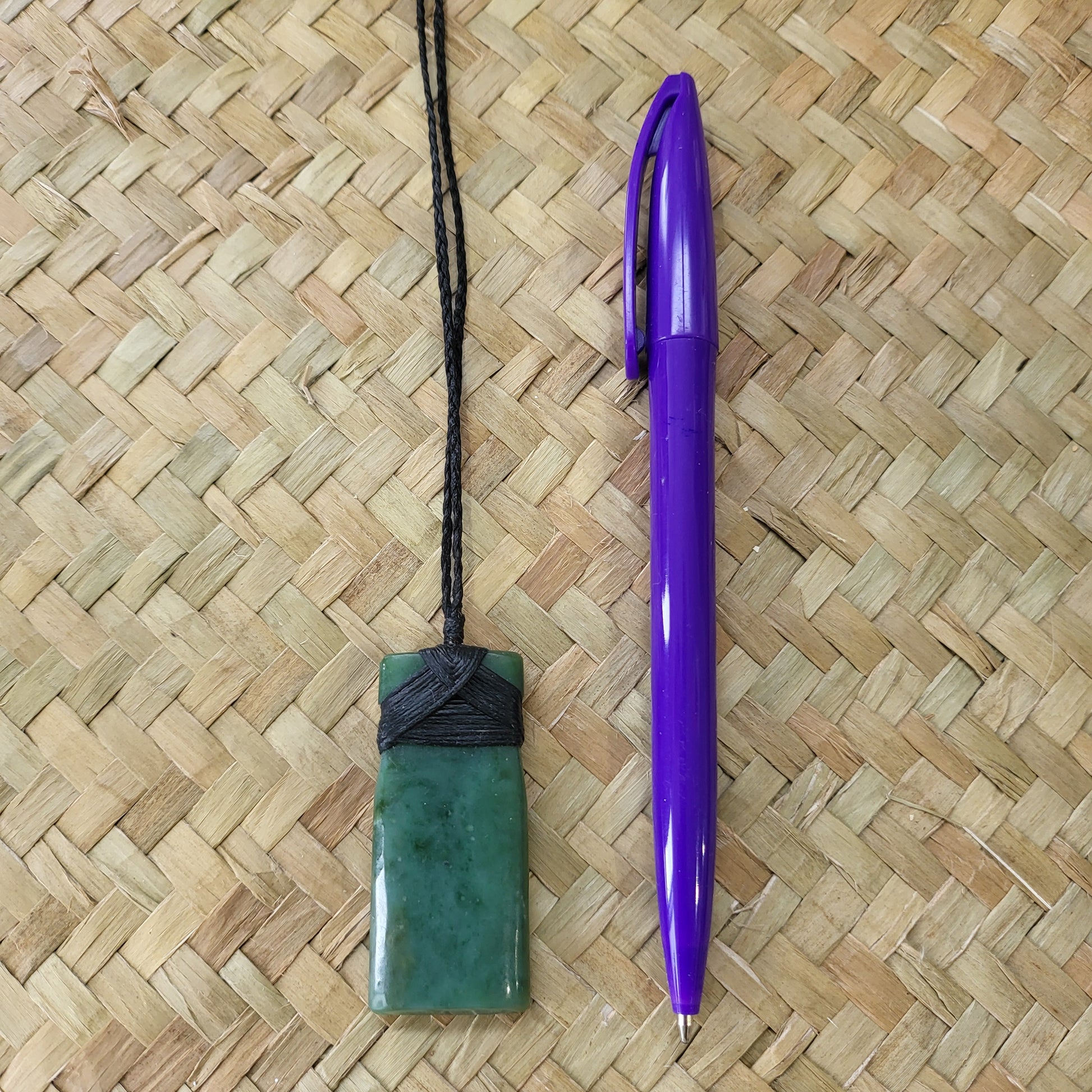 carved pounamu toki (adze) necklace, on black cord