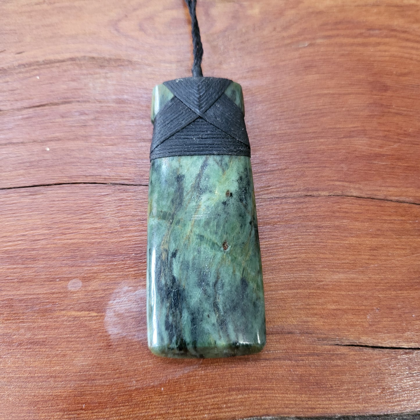 carved pounamu toki (adze) necklace, beautiful colour variations, on black cord