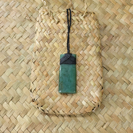 carved pounamu toki (adze) necklace, on black cord
