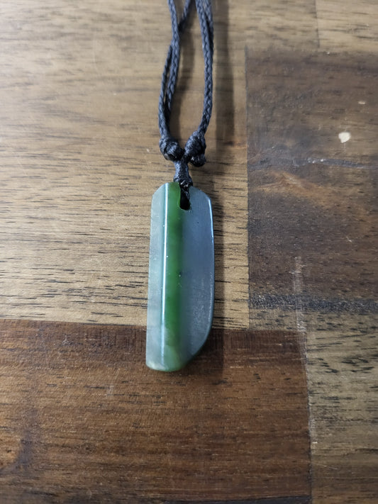 carved pounamu toki (adze) necklace, on black cord
