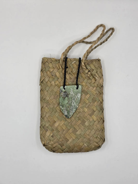 carved pounamu chest plate necklace on black cord
