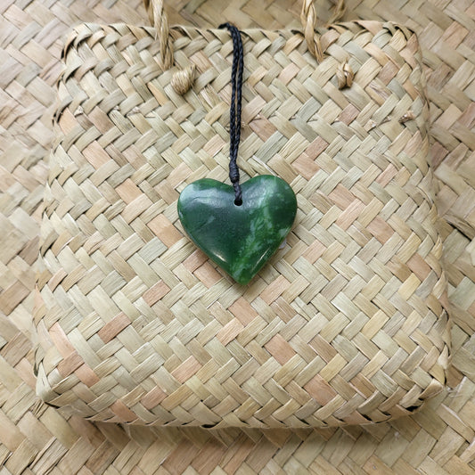 carved pounamu manawa (heart) necklace, beautiful colour variations, on black cord