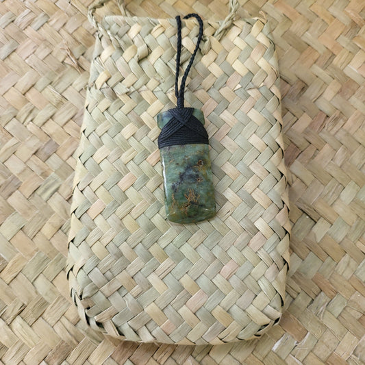 small carved pounamu toki (adze) necklace light green colour variations on black cord