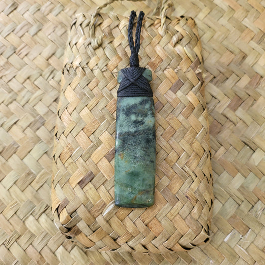 carved pounamu toki (adze) necklace light green colour variations on black cord