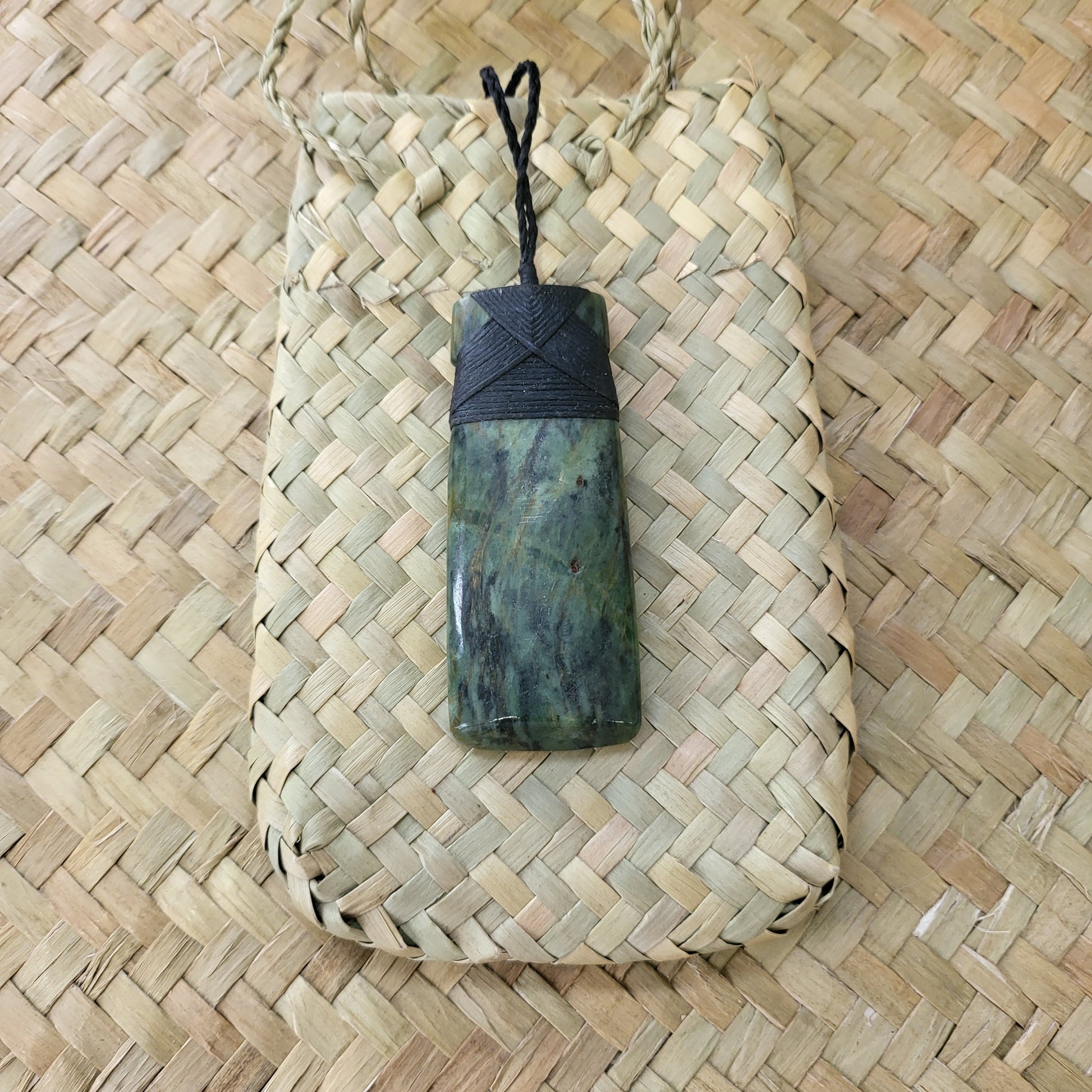 carved pounamu toki (adze) necklace, beautiful colour variations, on black cord