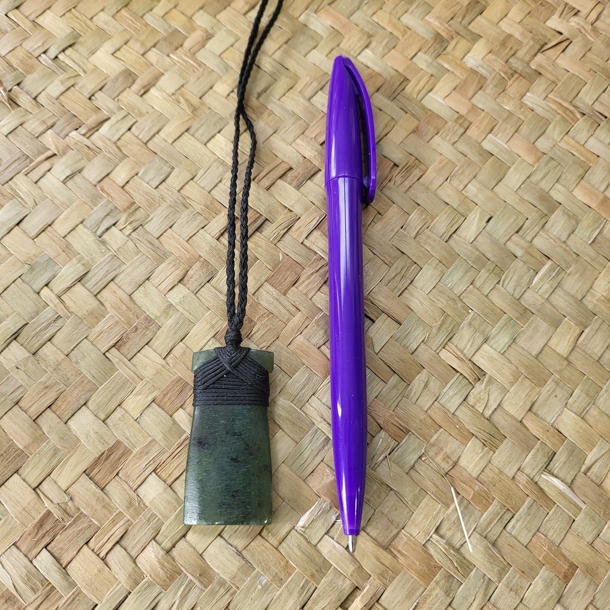 carved pounamu toki (adze) necklace, on black cord