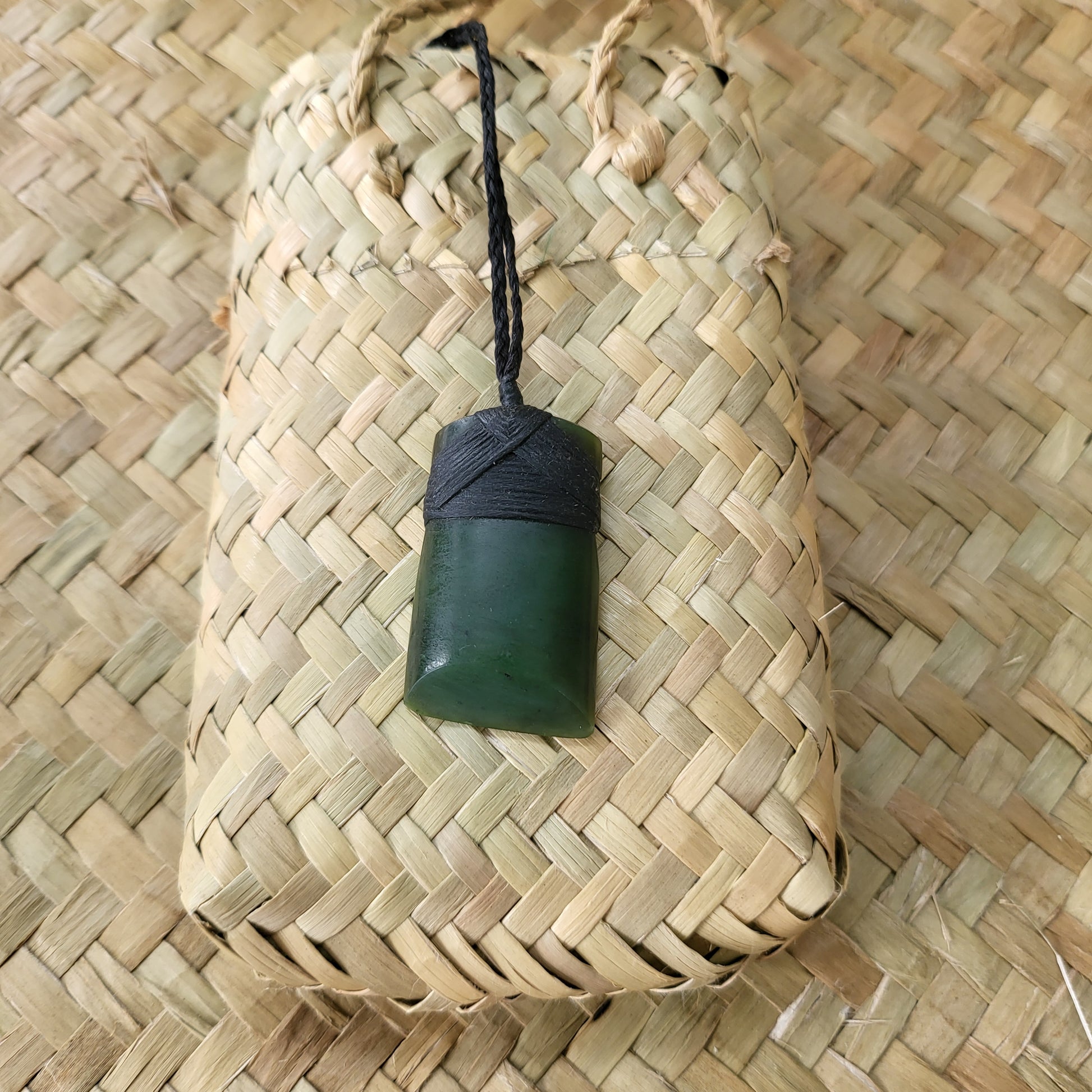 carved pounamu toki (adze) necklace, on black cord