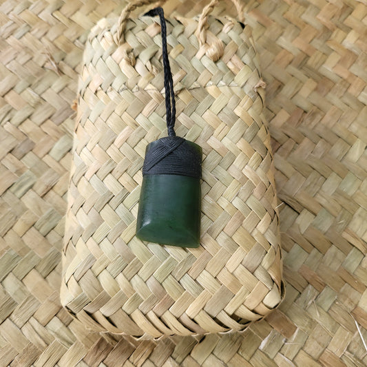 carved pounamu toki (adze) necklace, on black cord