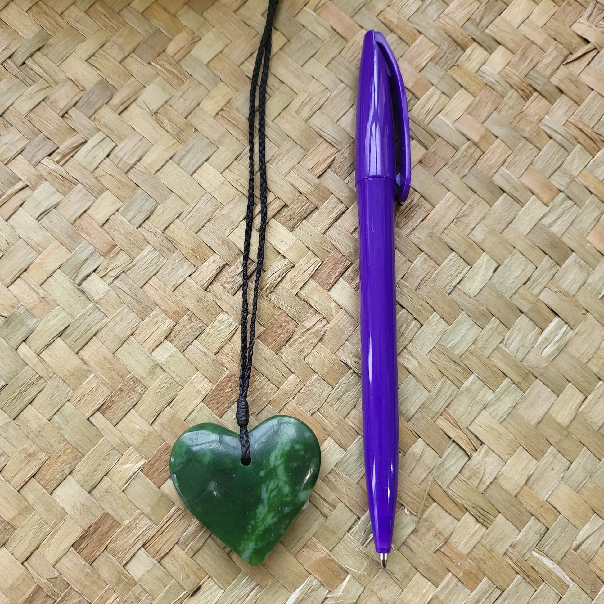 carved pounamu manawa (heart) necklace, beautiful colour variations, on black cord