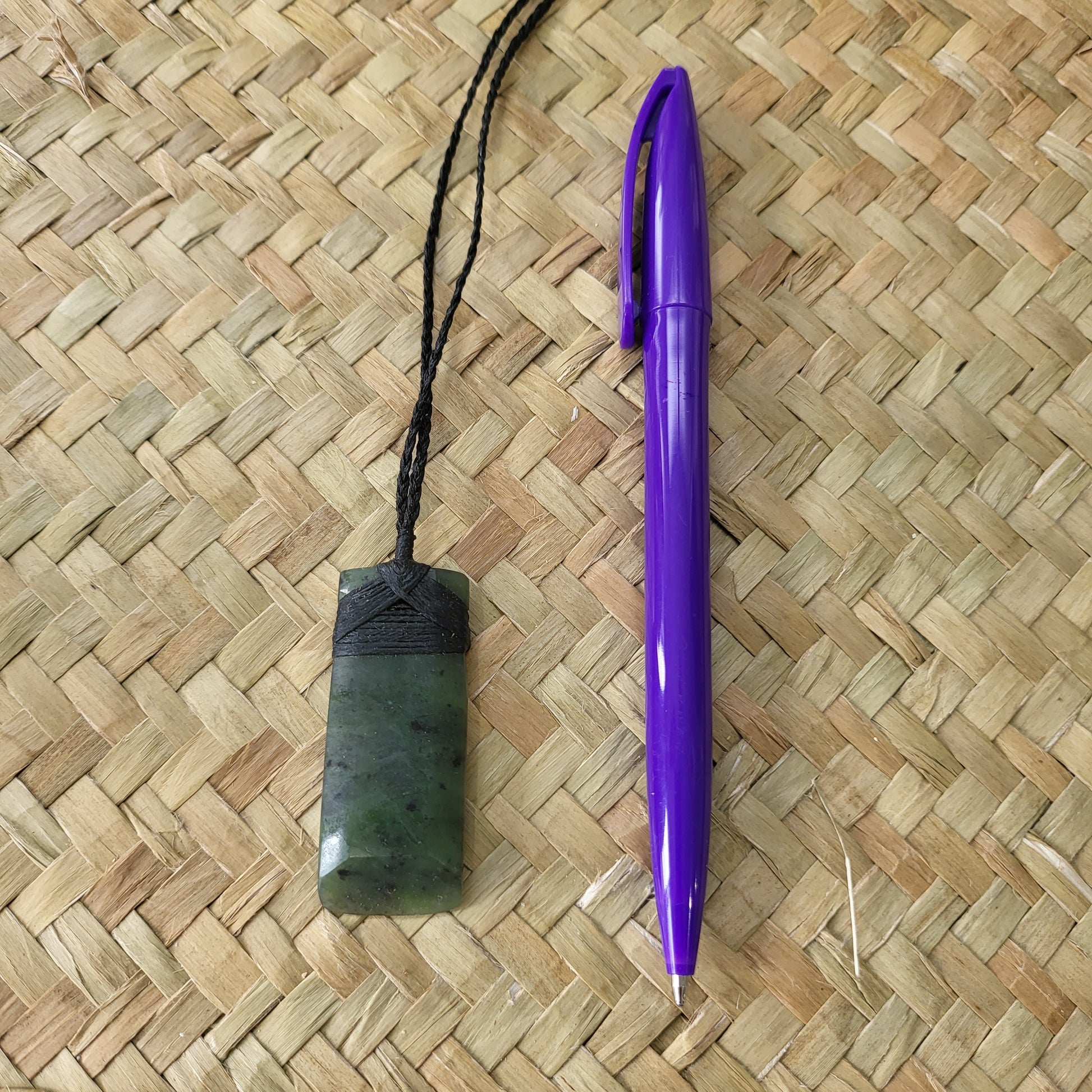 carved pounamu toki (adze) necklace, on black cord