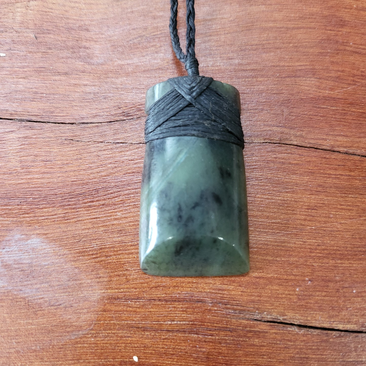 carved pounamu toki (adze) necklace, beautiful colour variations, on black cord