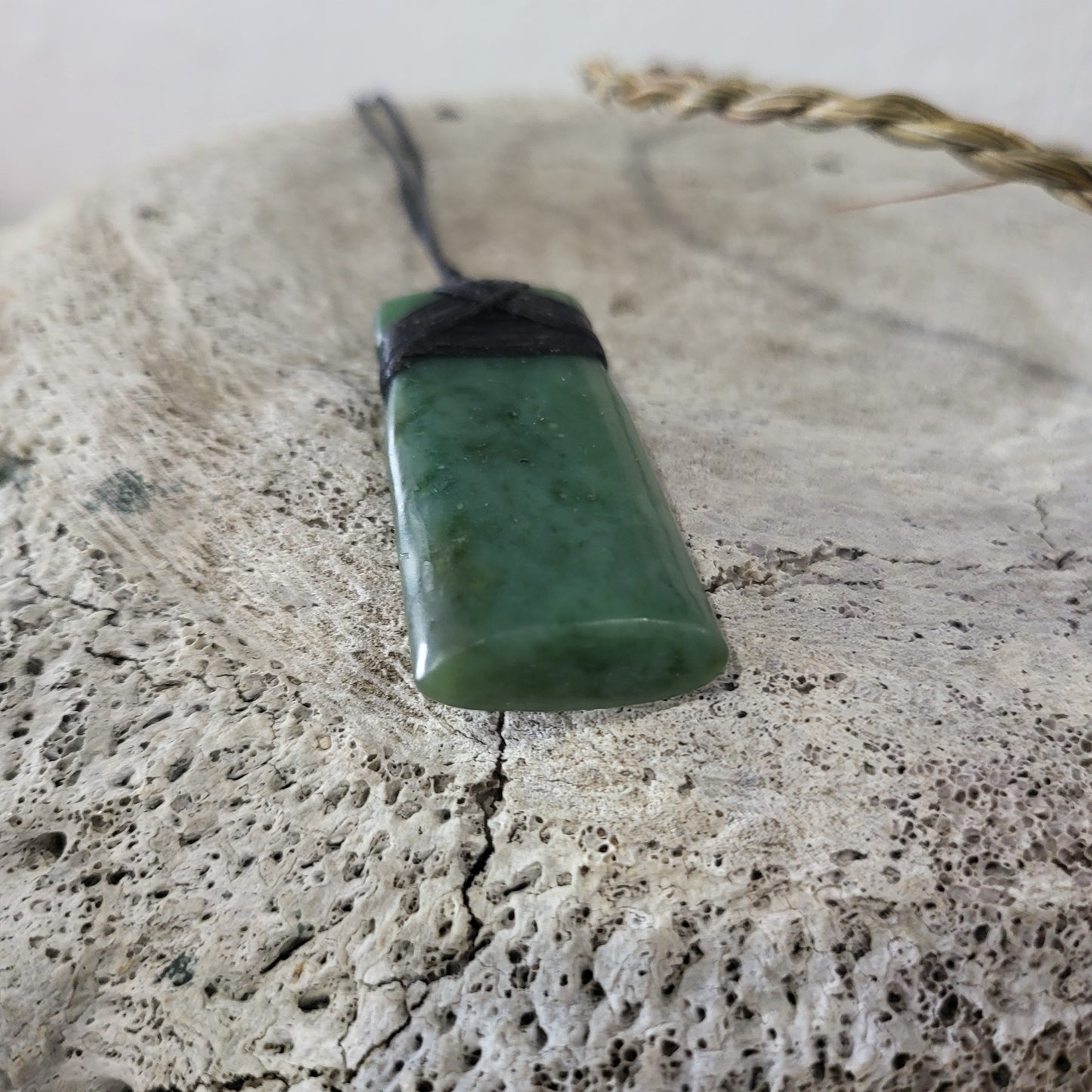 carved pounamu toki (adze) necklace, on black cord