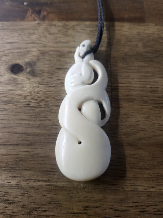 carved bone and paua manaia necklace on black cord
