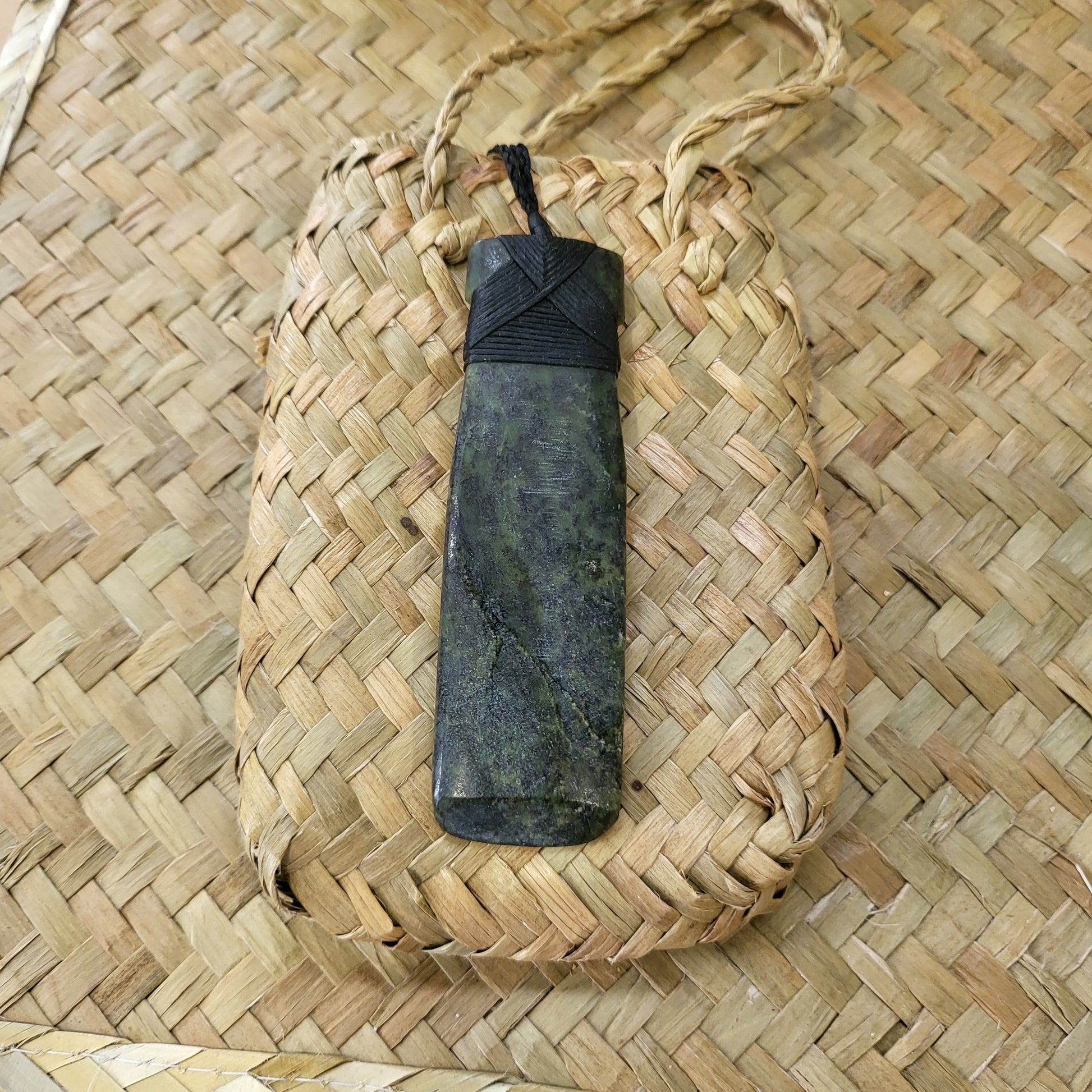 carved pounamu toki (adze) necklace, on black cord