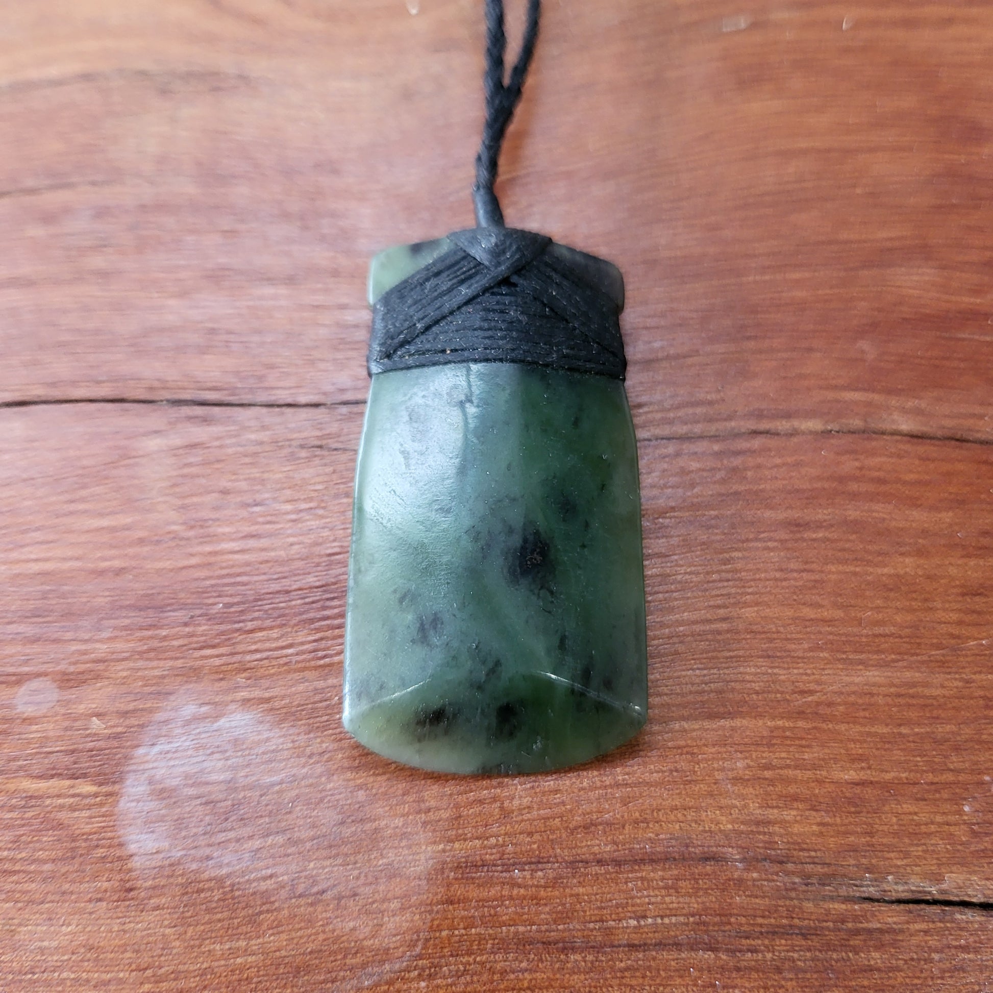 carved pounamu toki (adze) necklace, on black cord