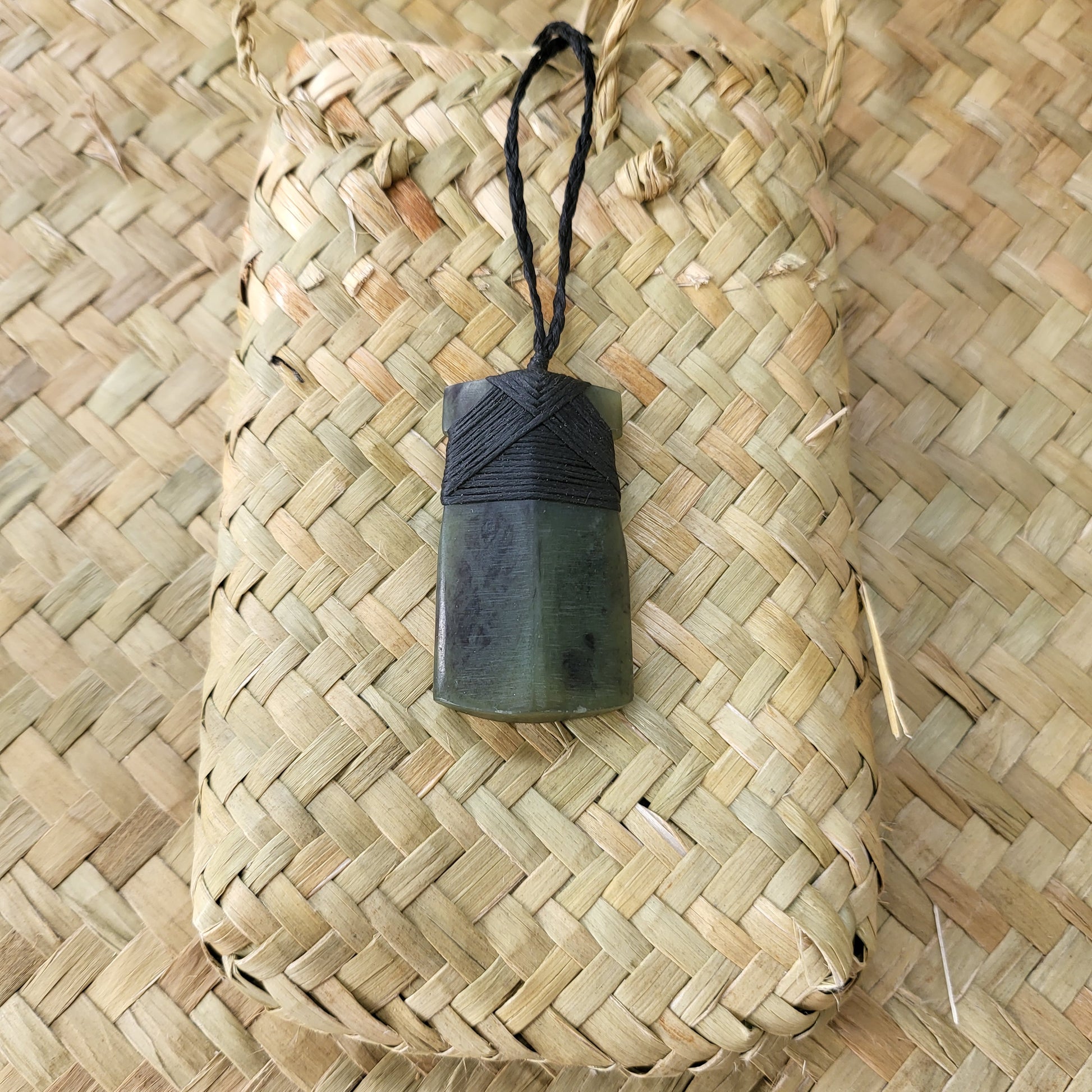 carved pounamu toki (adze) necklace, on black cord