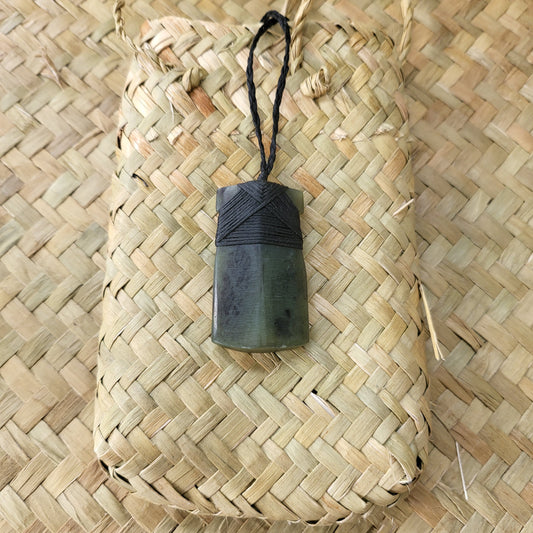 carved pounamu toki (adze) necklace, on black cord