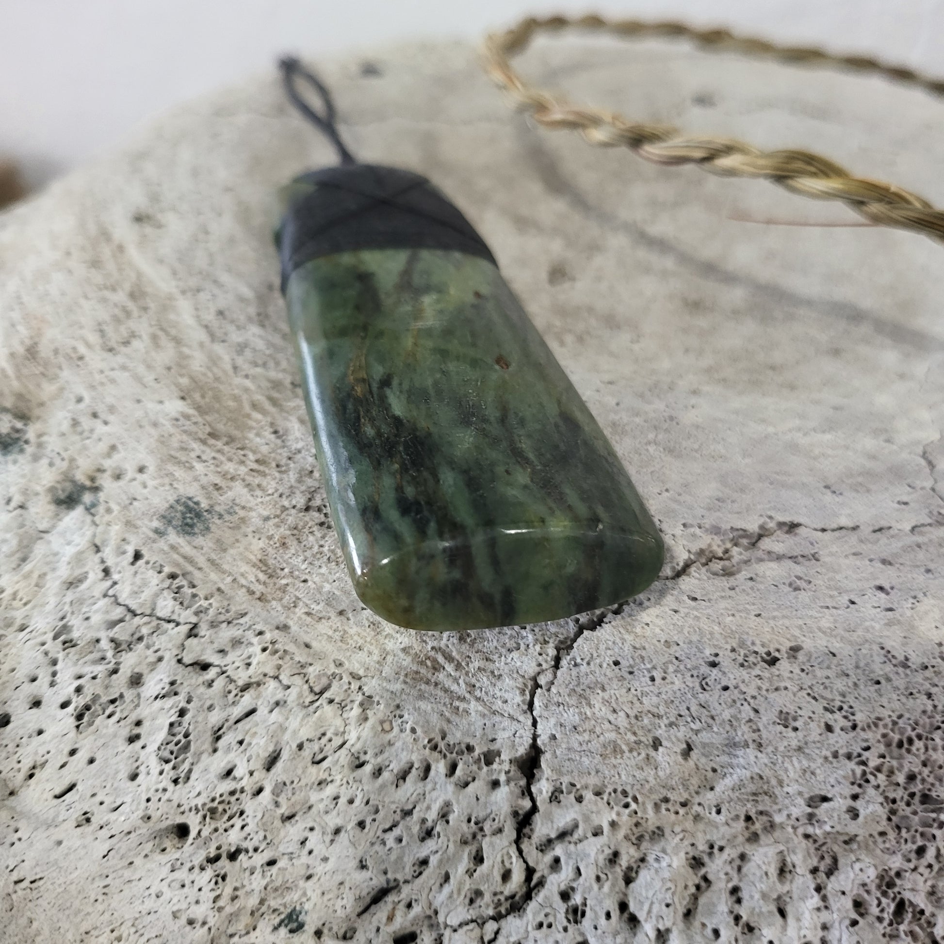 carved pounamu toki (adze) necklace, beautiful colour variations, on black cord