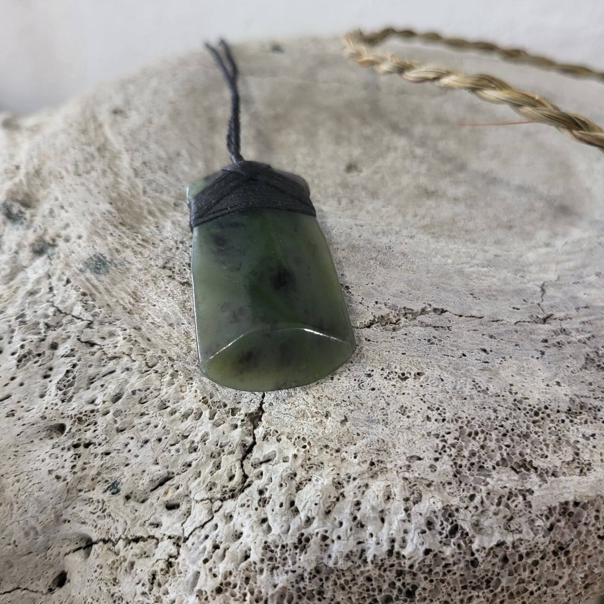 carved pounamu toki (adze) necklace, on black cord