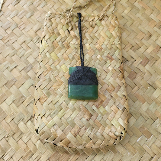 small carved pounamu toki (adze) necklace, on black cord